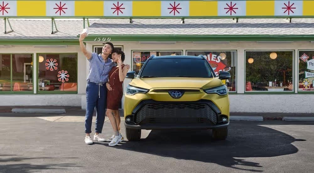 A yellow 2024 Toyota Corolla Cross is shown parked on a parking spot after visiting a Toyota dealer near Dunwoody.