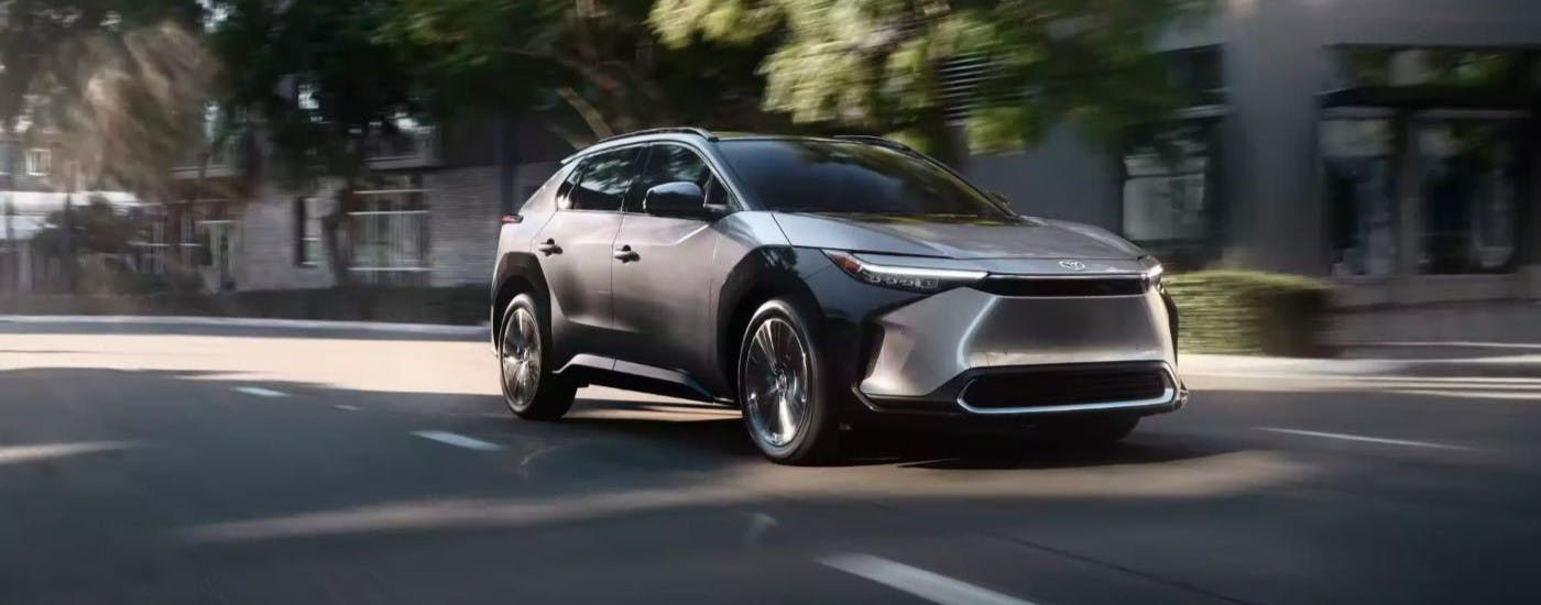Silver 2023 Toyota bZ4X Limited driving to a Toyota dealer near you