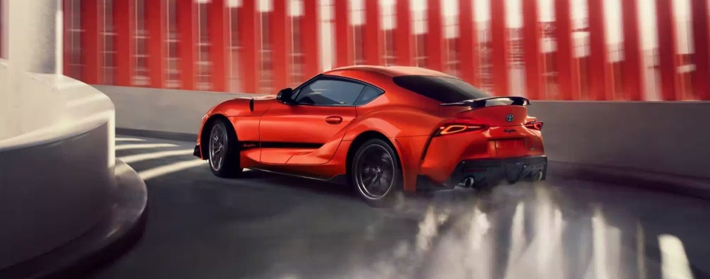 Orange 2024 Toyota GR Supra 45th Anniversary Edition driving up a ramp