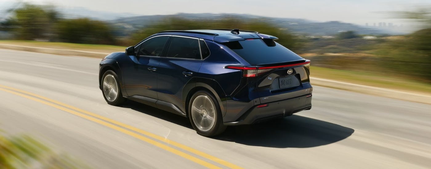 Dark blue 2026 Toyota bZ driving to a Toyota dealer near Powder Springs