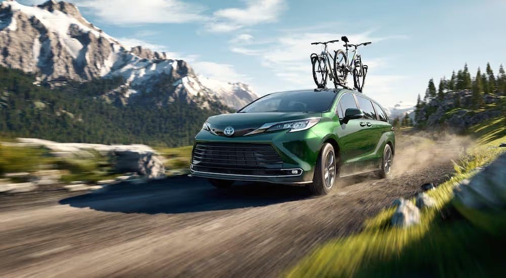 A green 2021 Toyota Sienna is shown driving off-road.