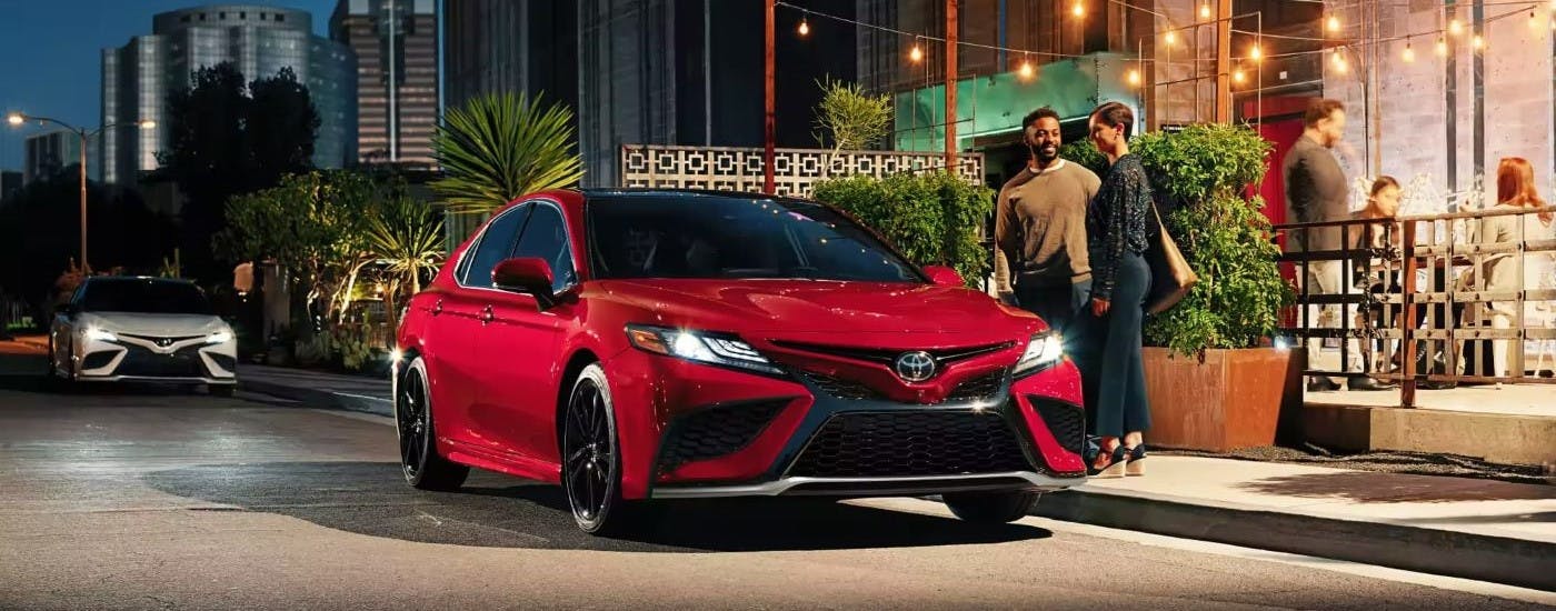 Red 2023 Toyota Camry parked at a restaurant