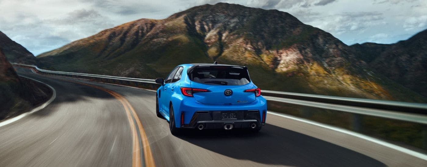 Blue 2024 Toyota GR Corolla Circuit Edition driving down a road
