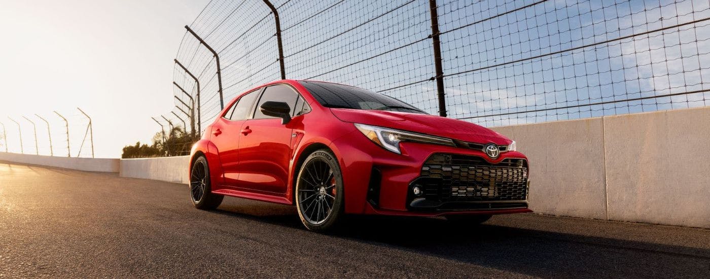 Red 2024 Toyota GR Corolla Premium driving on a track.