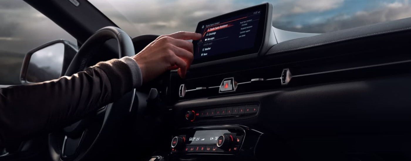 Person using the infotainment screen a 2023 Toyota GR Supra