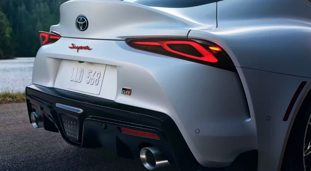 Rear end of a white 2025 Toyota GR Supra Premium with dual exhaust.