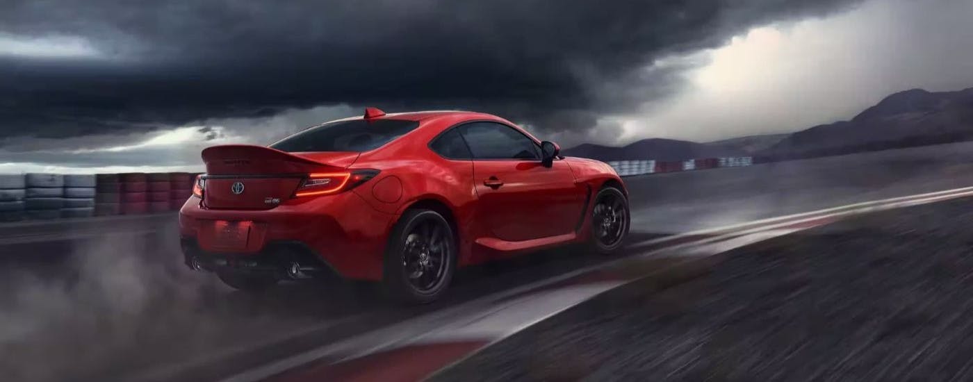 Red 2024 Toyota GR86 driving on a track