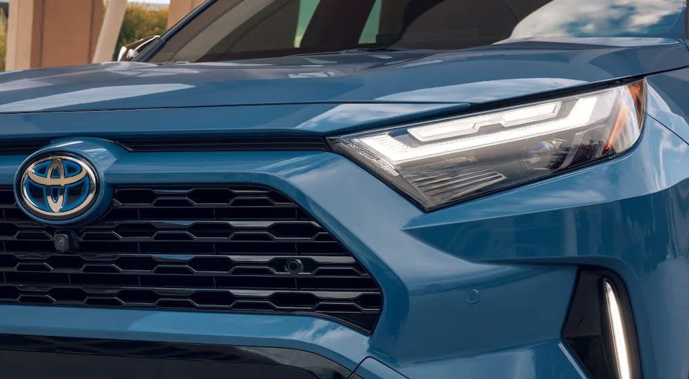 A close up of the grille on a blue 2024 Toyota RAV4 Hybrid XSE for sale.