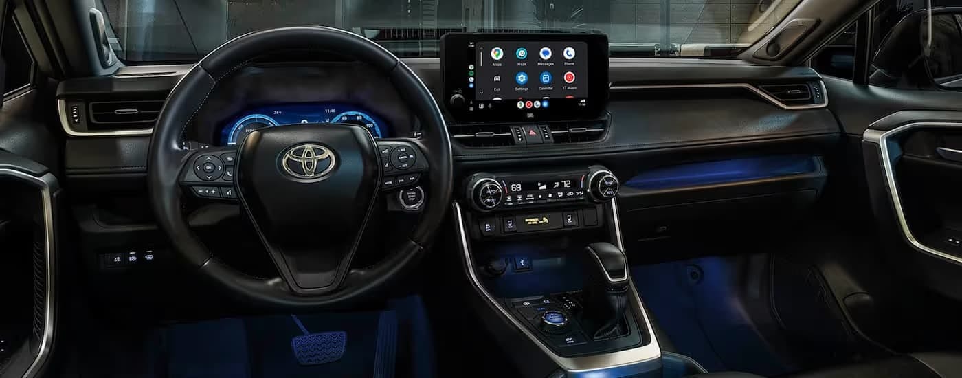 The wheel and dashboard inside of a 2025 Toyota RAV4.