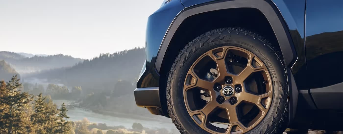 Close-up on the front wheel of a dark blue 2025 Toyota RAV4.