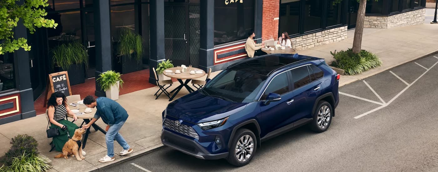 Dark blue 2026 Toyota RAV4 parked by a curb.