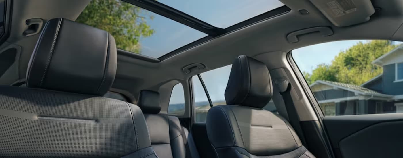 The front seats and sunroof inside of a 2025 Toyota RAV4.