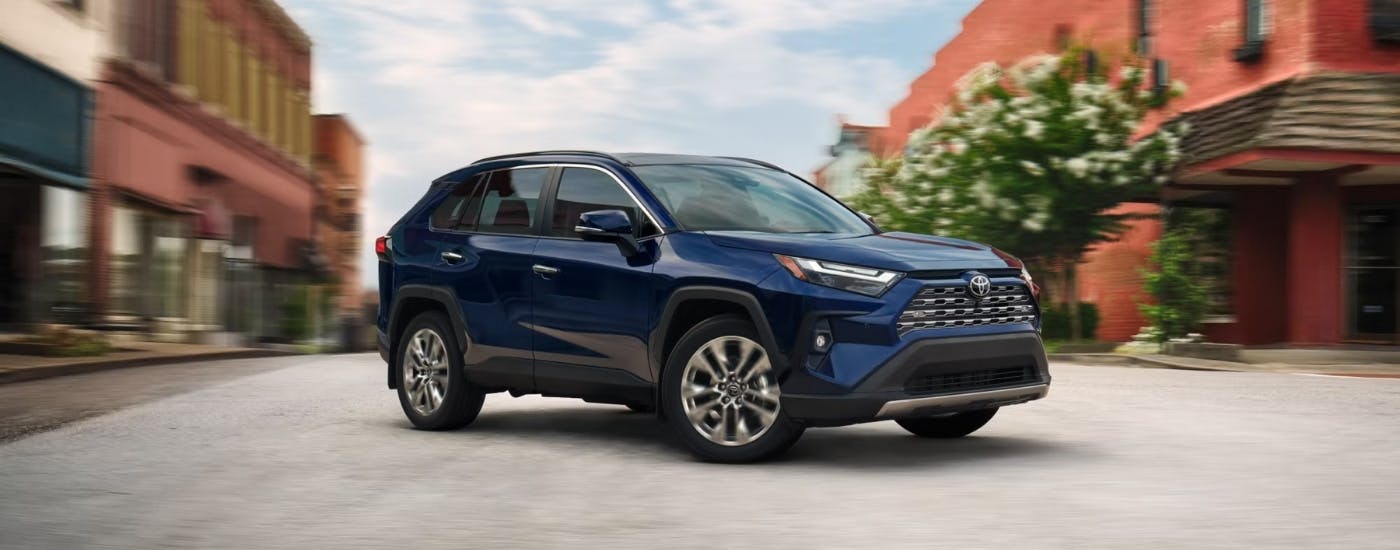 Blue 2025 Toyota RAV4 for sale near Woodstock driving in a city