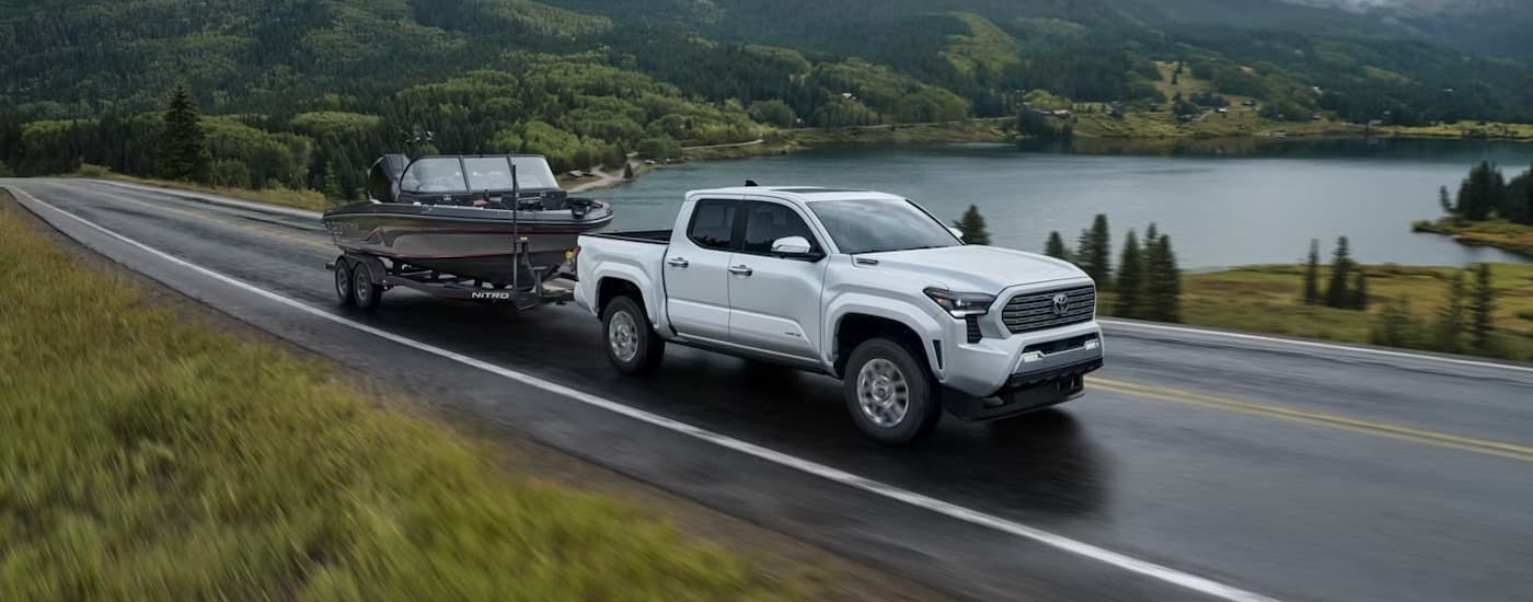 Silver 2025 Toyota Tacoma towing a boat