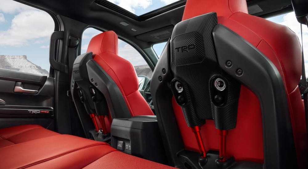 The red seats in a 2025 Toyota Tacoma TRD Pro are shown from the rear seats.