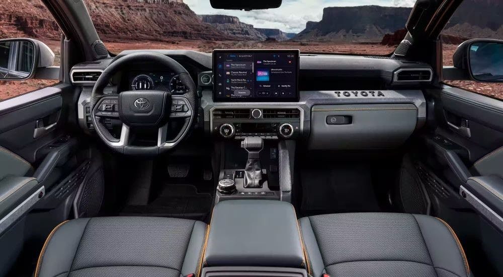 The gray interior and dash are shown in a 2025 Toyota Tacoma.