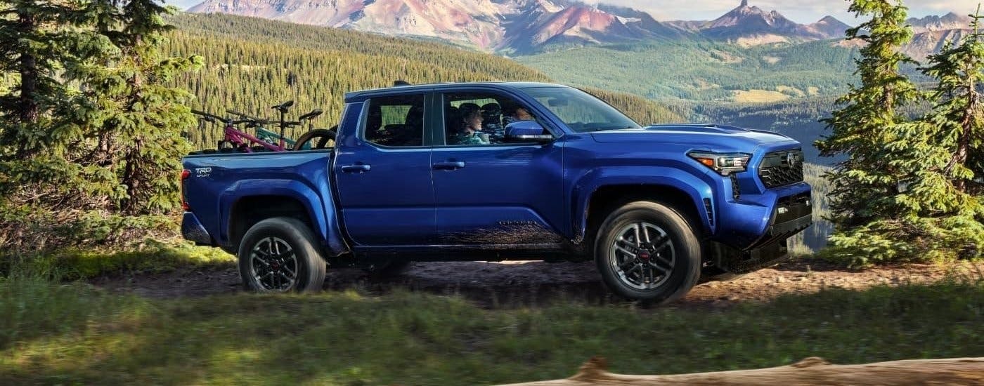 Blue 2025 Toyota Tacoma from the side.