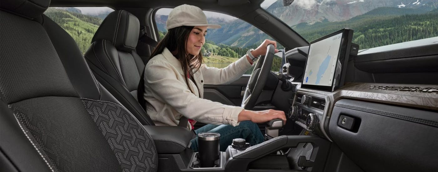 Person using the gear shifter in a 2025 Toyota Tacoma 
