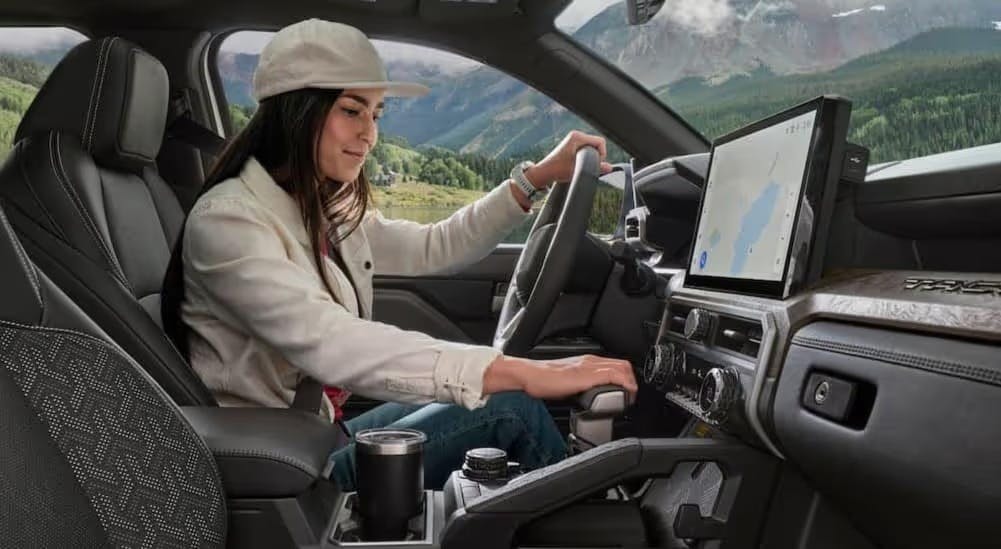 The black interior and dash in a 2024 Toyota Tacoma is shown.