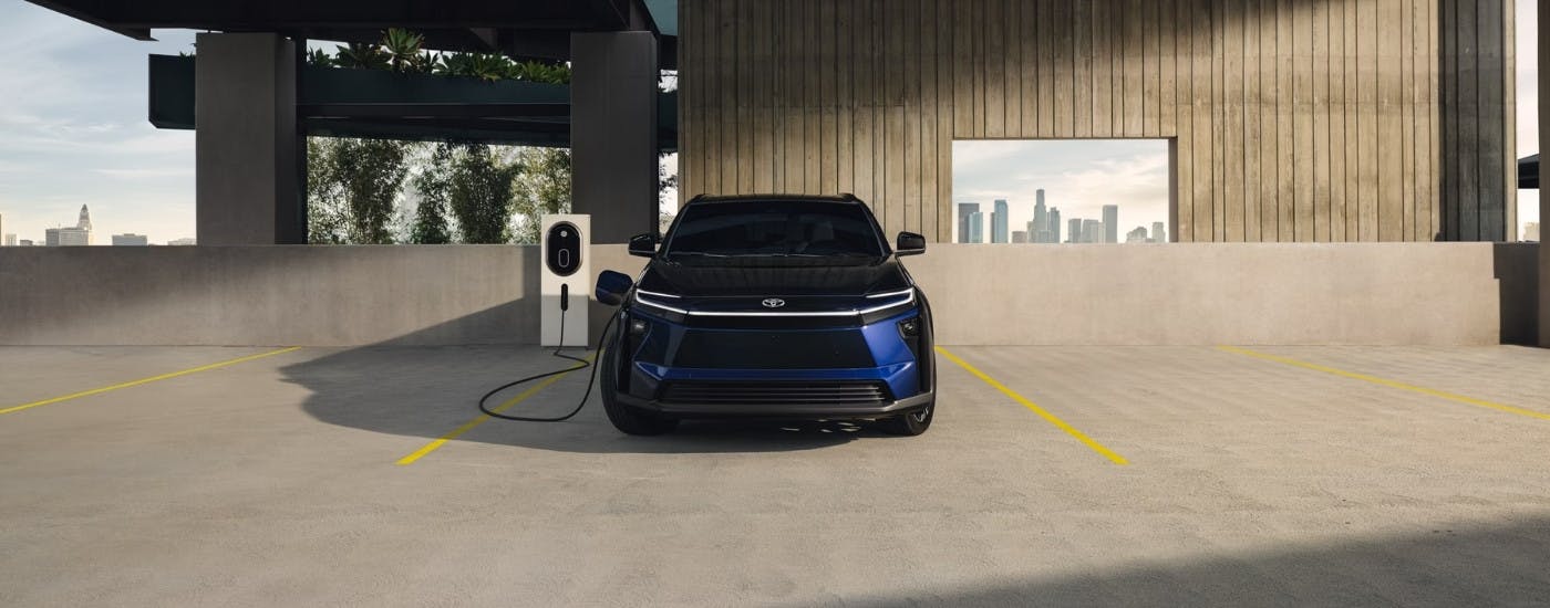 Blue 2026 Toyota bZ charging in a garage