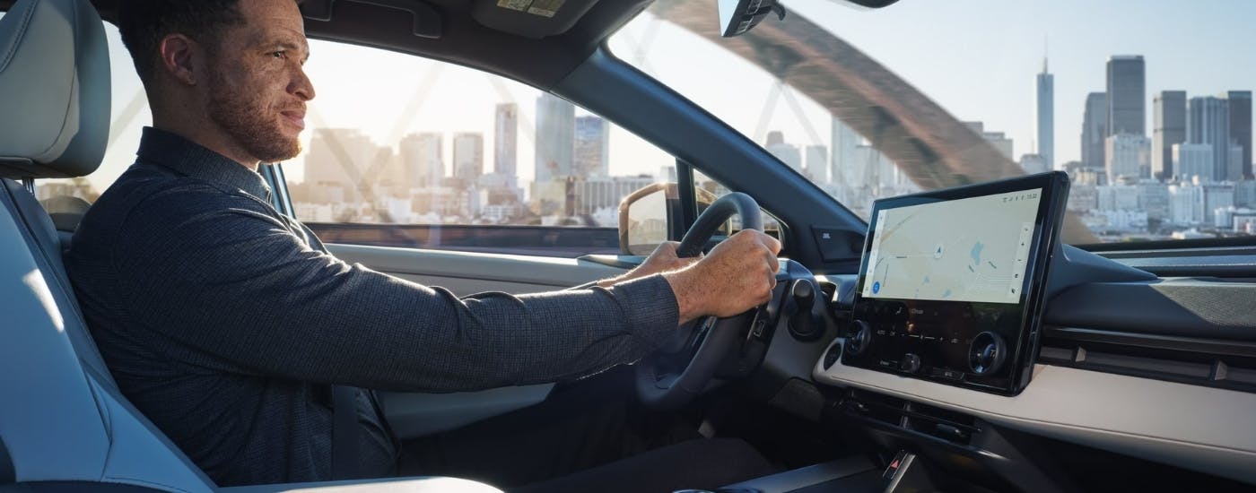 A person drives a 2026 Toyota bZ into a city