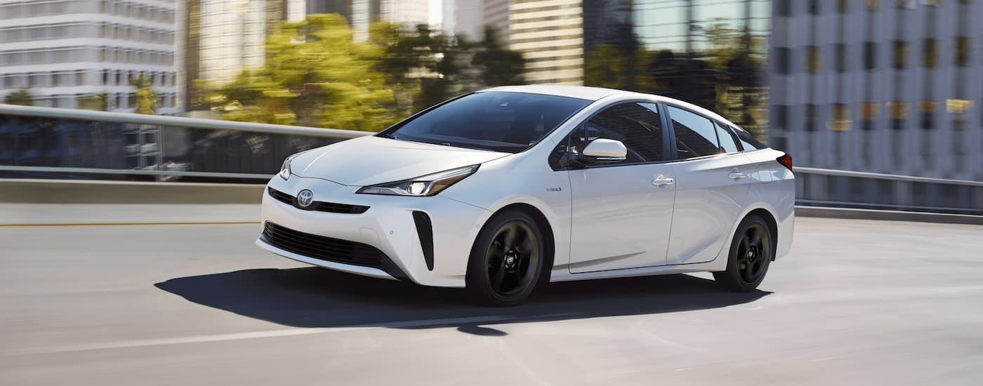 White 2020 Toyota Prius driving on a city street