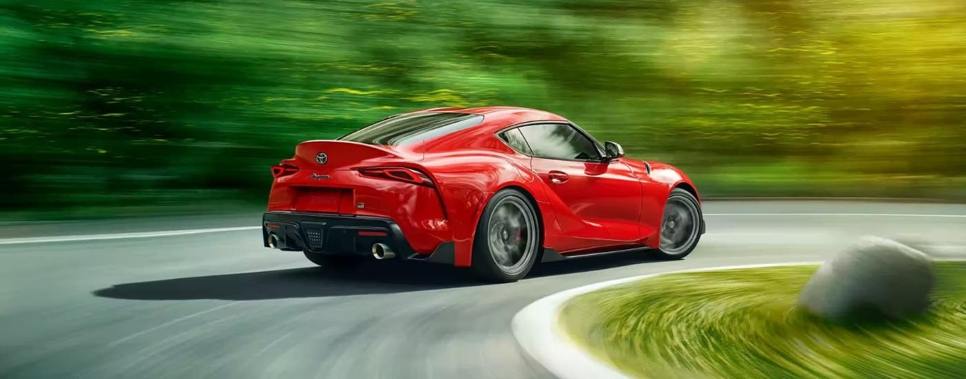 Red 2021 Toyota Supra rounding a corner