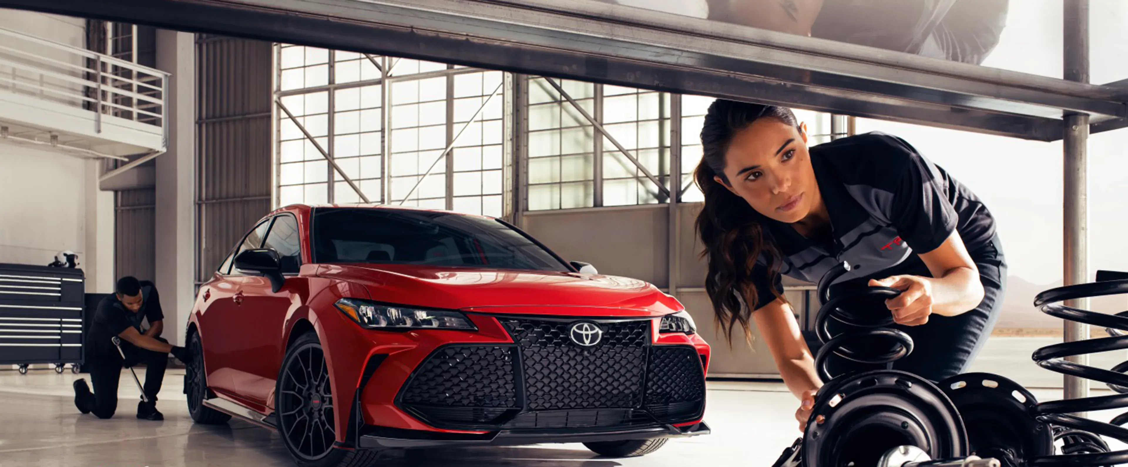 Toyota service technician working on a vehicle in the service center