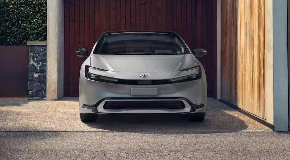 A silver 2023 Toyota Prius is shown parked on a driveway.