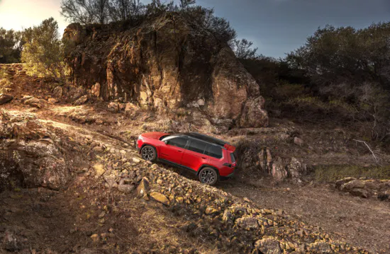 red SUV driving uphill