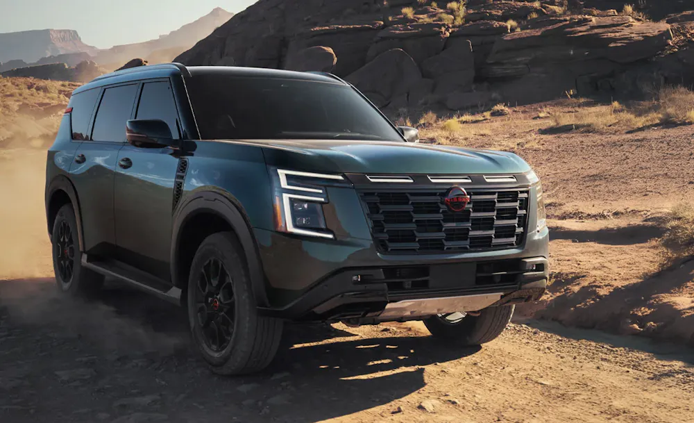 Nissan SUV driving through desert terrain
