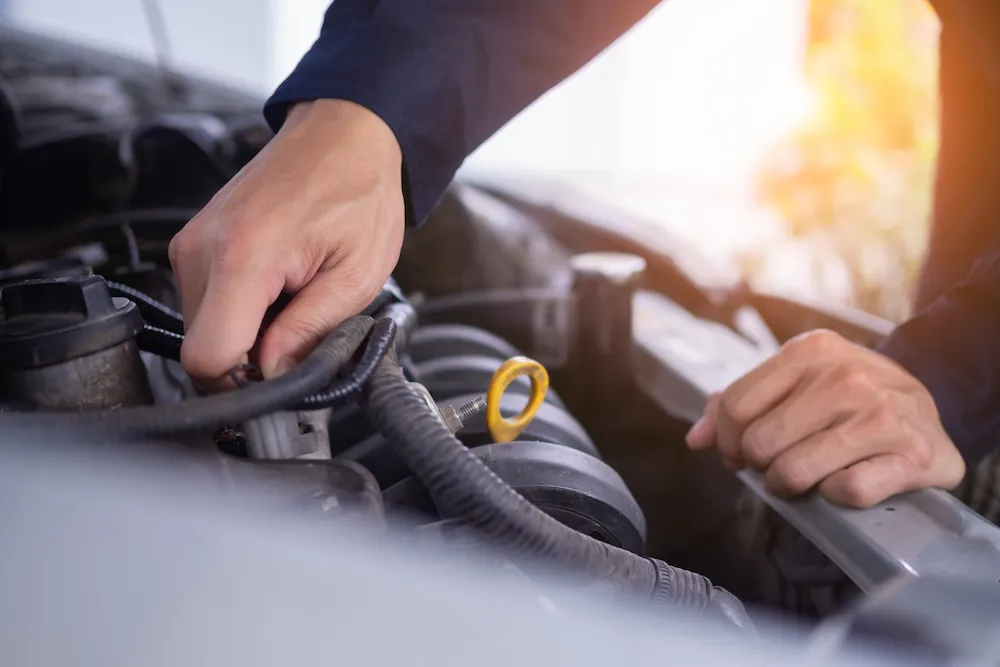 car mechanic working up close on vehicle