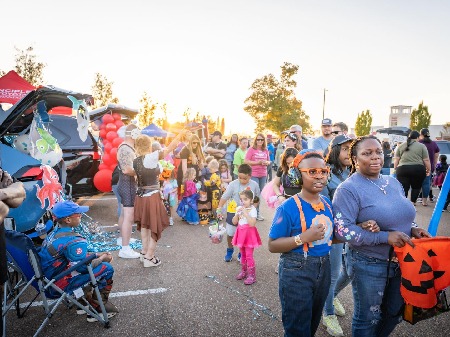 a bunch of families hanging out during Trunk of Treat