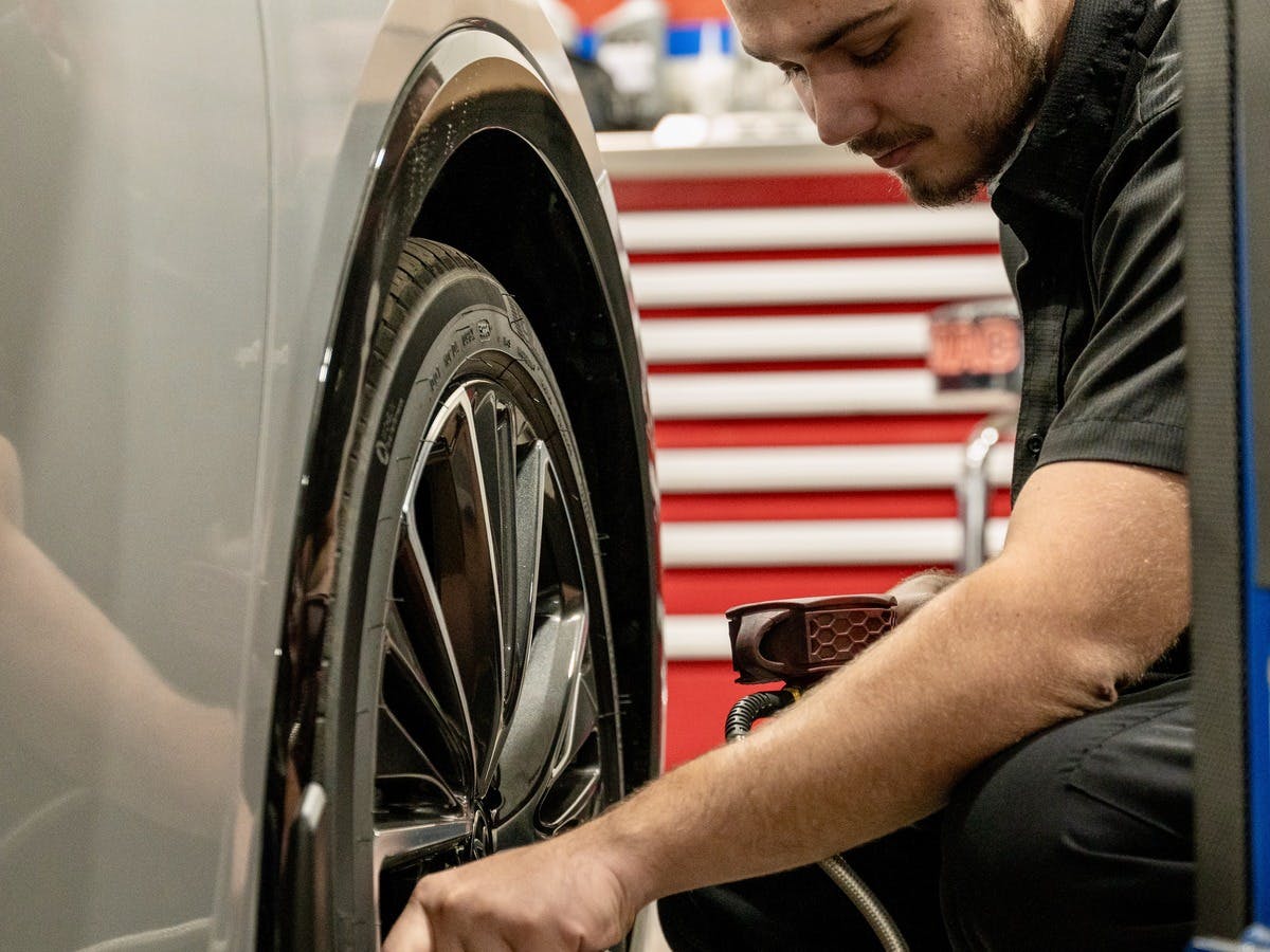 Service technician installing a new brake.