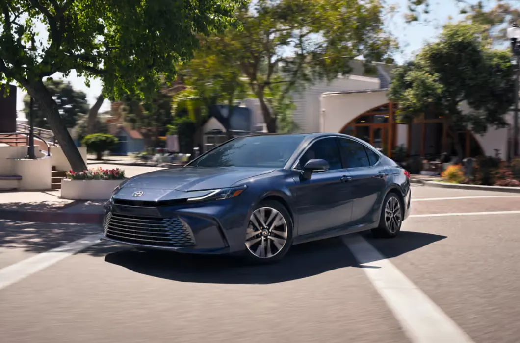 Toyota Camry driving down the street