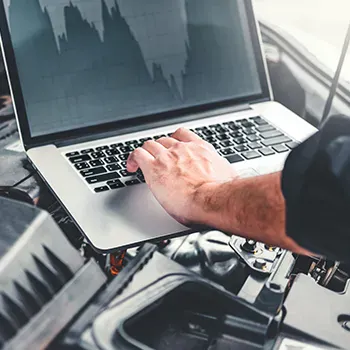 A person types on a laptop keyboard