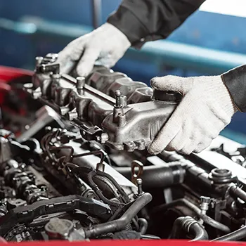 Diesel repair technician working on engine