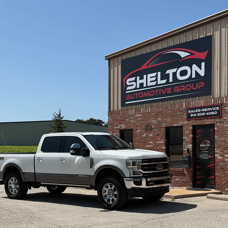 A Ford F-250 parked at an angle outside Shelton Automotive Group dealership