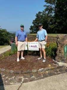 IMG_7123-300×225 Two Better Business Bureau golf tournament entries standing by event sign on course
