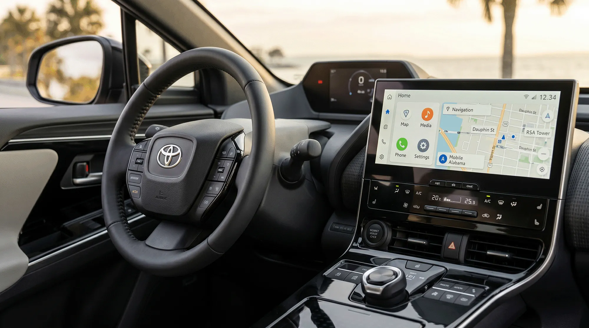 Close-up of 2026 Toyota electric SUV interior with steering wheel, digital cluster, and infotainment navigation screen