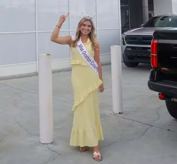 Miss Gaston County standing in front of dealership