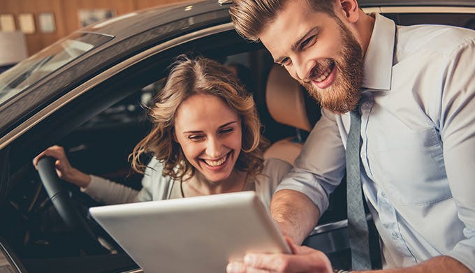 Associate helping out a woman with a car order