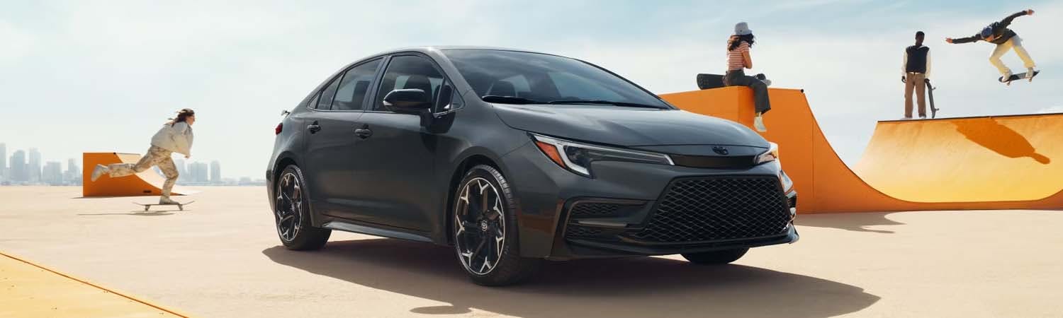 Dark grey 2025 Toyota Corolla parked at skatepark.