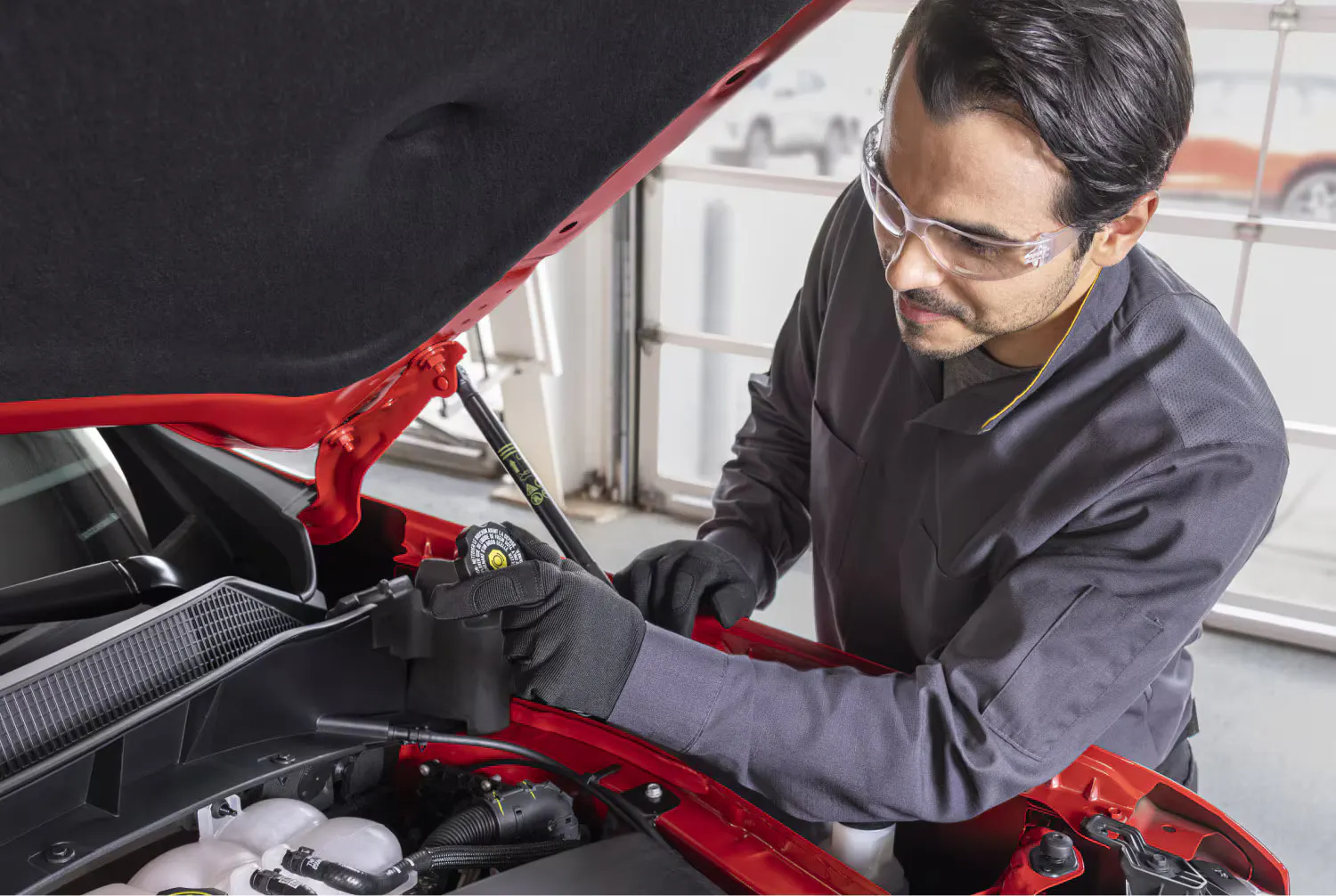 A man working on a vehicle.