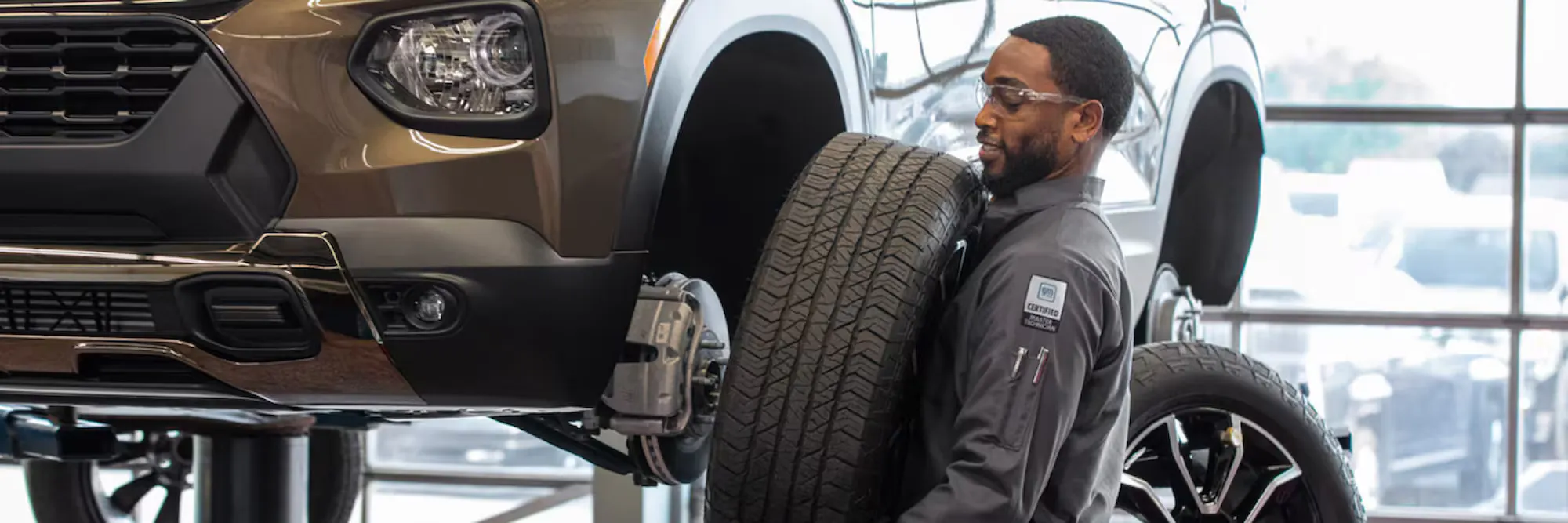 a view of a certified chevy service member taking care of tires on a chevy vehicle