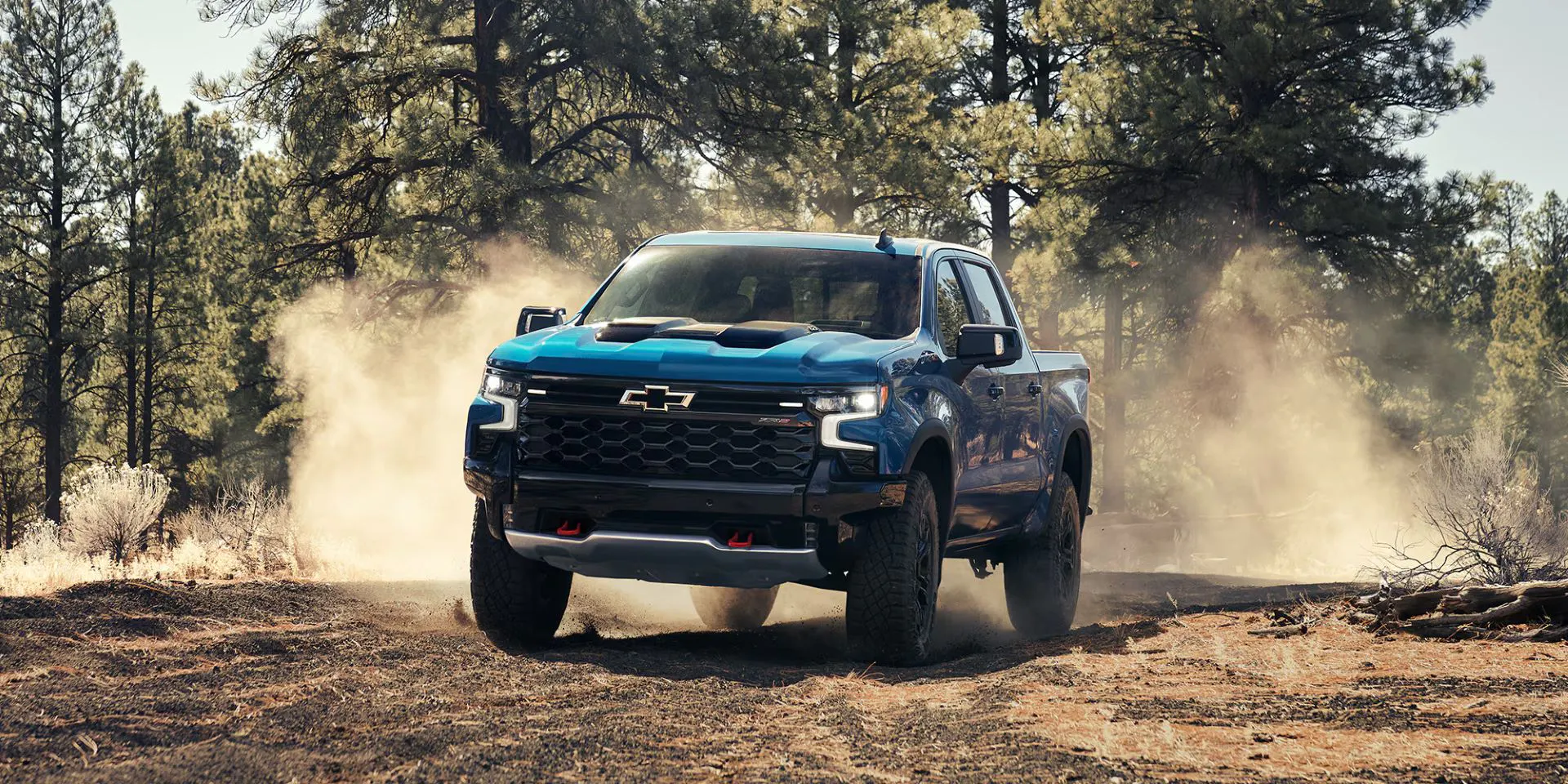 A blue 1500 driving off-road.