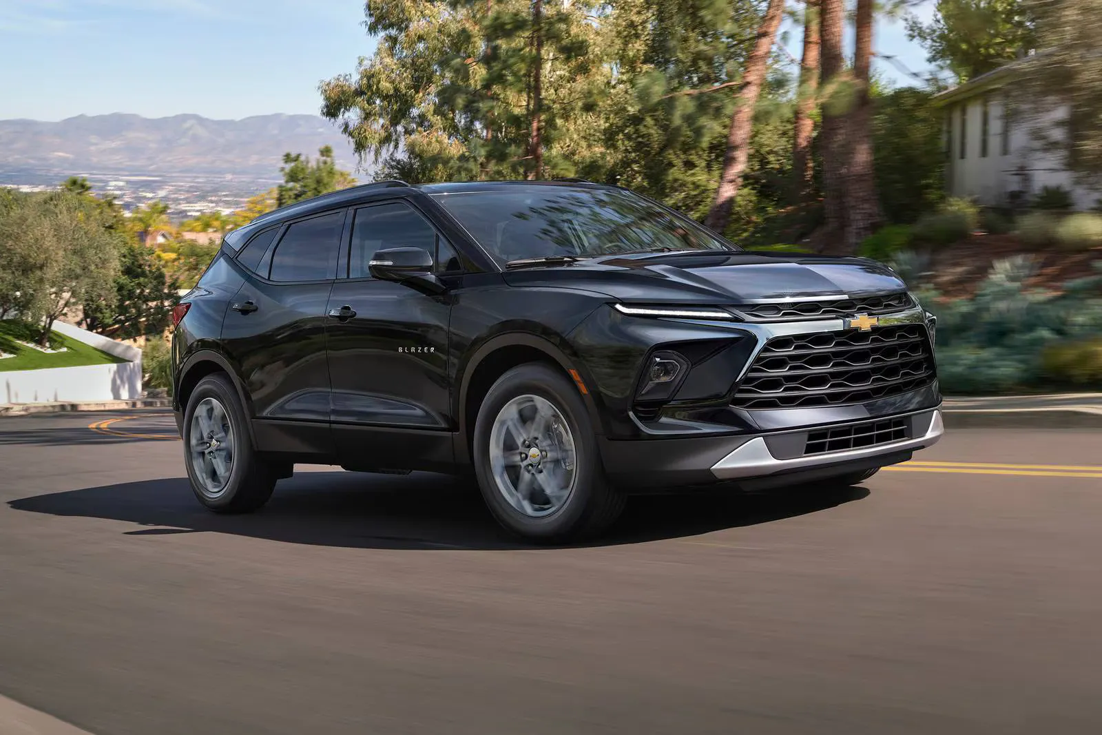 A black blazer driving on the road.