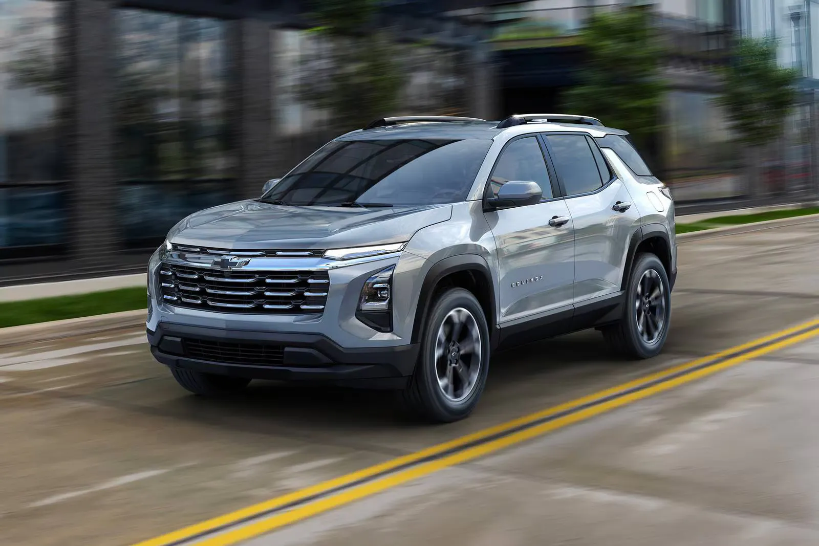 A silver suv driving on the road.