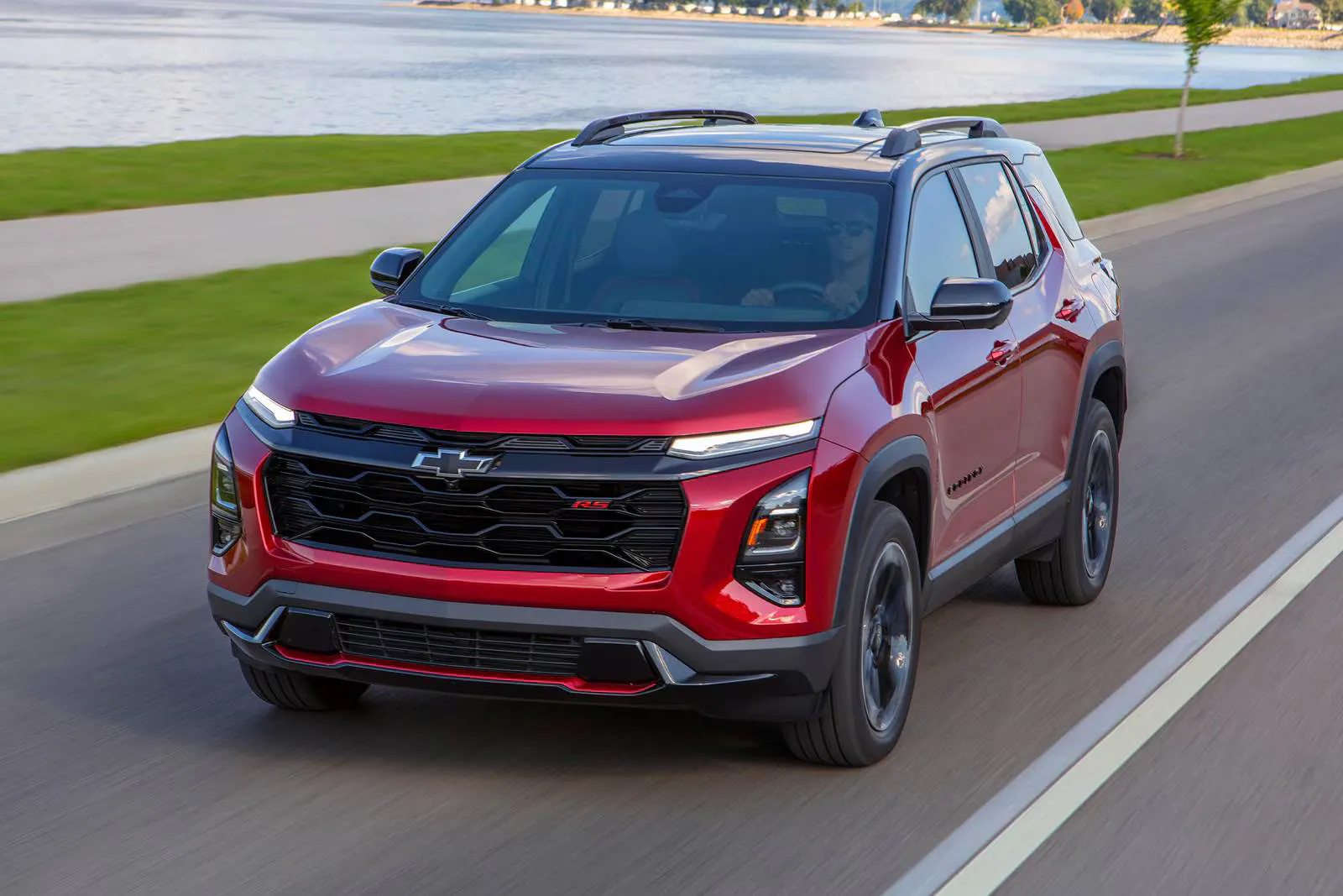A red suv driving on the road.