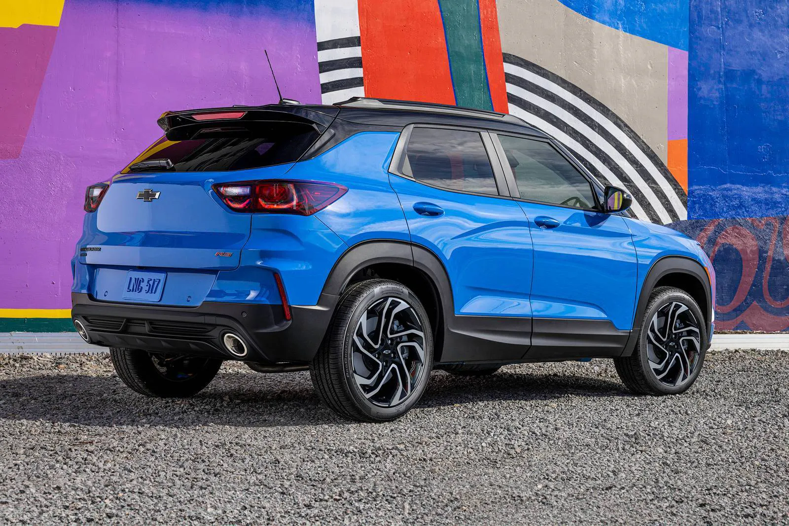 A blue trailblazer sitting parked.